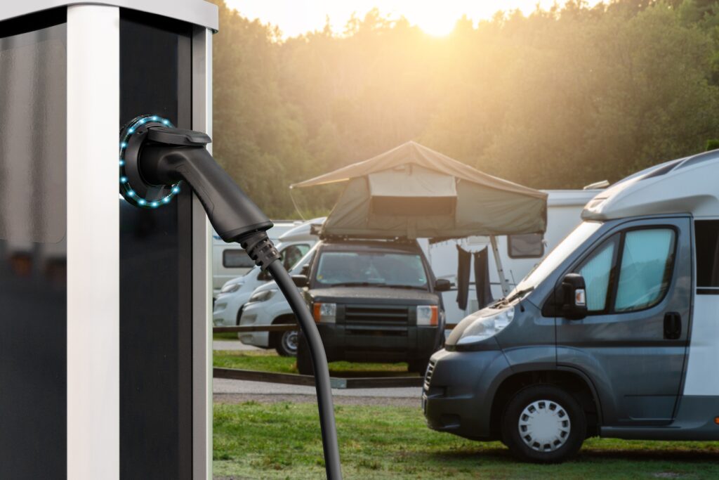 Charging station for electric car against the backdrop of a campsite